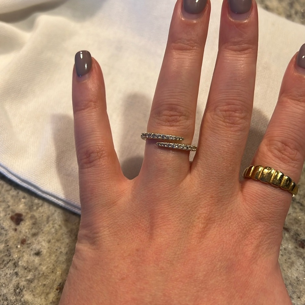 Diamond encrusted gold ring with an open twist